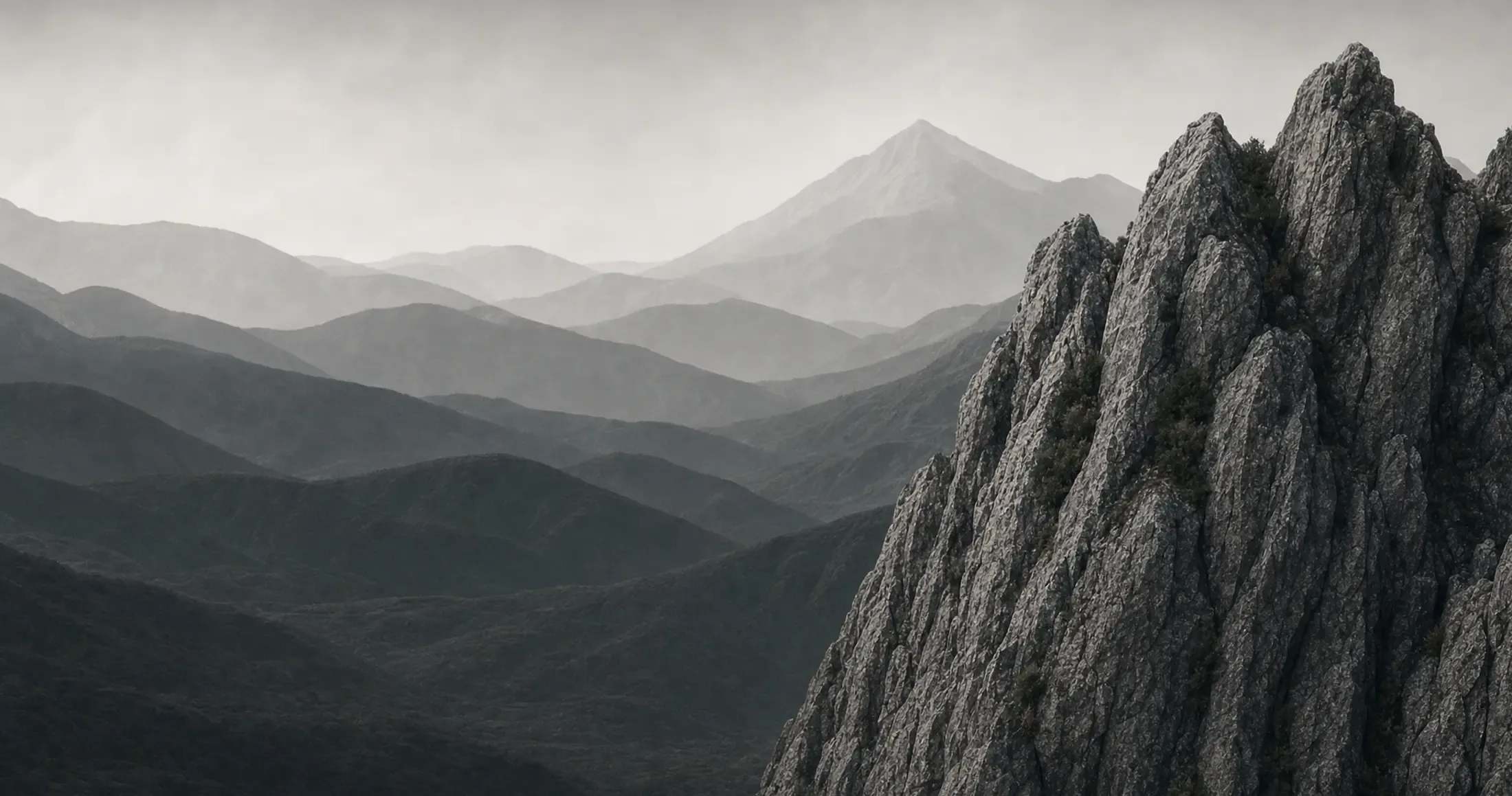 Misty mountain landscape with a granite rock face